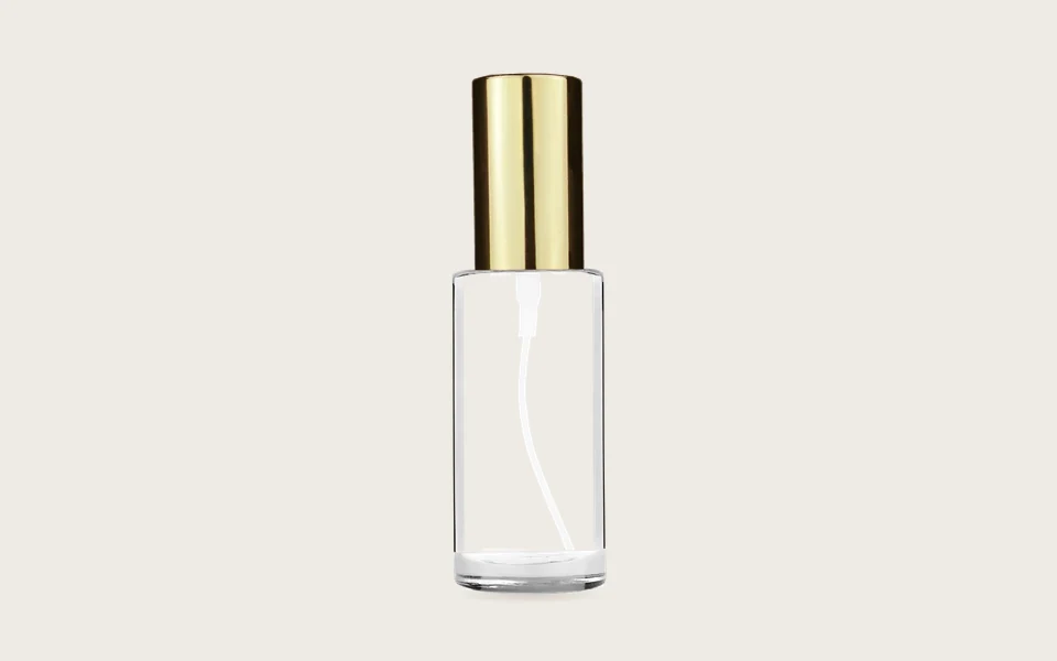 A clear 25 ml Cylinder bottle with a shiny gold spray cap